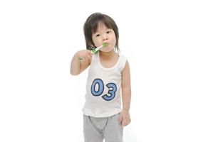 Little asian boy brushing teeth