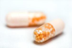 Medicine prescribed capsules on white photo