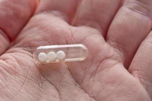 capsule pill with homeopathy in macro hand