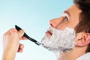 Man shaving with razor face profile photo