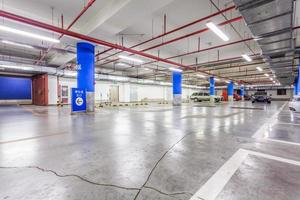 Parking garage, underground interior with a few parked cars photo