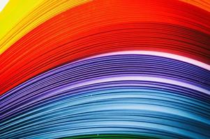Rainbow colored quilling paper laid out in waves and shapes photo
