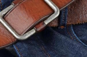 Blue jeans with leather belt photo