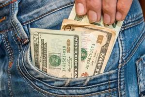 Male hand with dollars in the pocket photo
