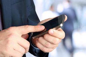 Businessman holding  and using the  mobile  smartphone