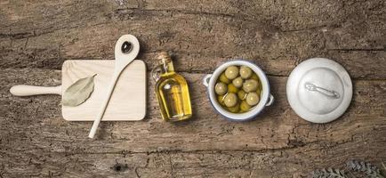 OLive oil and olives wooden table photo