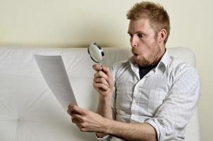 Portrait of handsome young man reading a contract photo