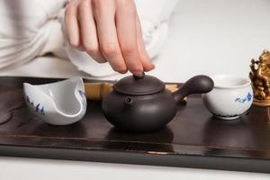 Chinese tea ceremony is perfomed by master photo