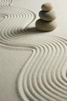 Stack of stones on raked sand photo