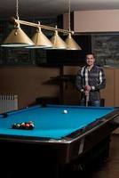 Portrait Of A Young Man Playing Billiards photo