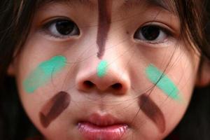 Face of a Native American child's with painted markings photo