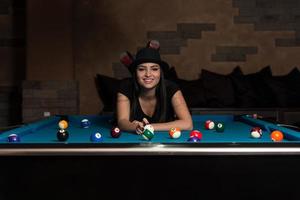 Young Woman Lying On The Billiard Table photo