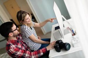 Young attractive designers working together from home photo
