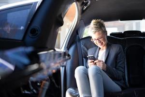 Businesswoman texting and smiling photo