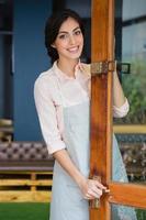Portrait of waitress standing at the entrance photo