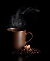 aromatic cup of coffee with smoke and beans photo