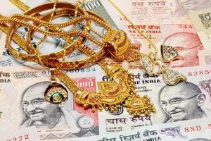 Gold ornaments on Indian currency photo