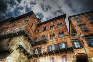 old building in Siena under a dramatic sky