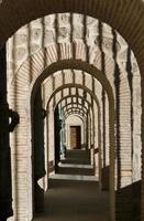 an arched corridor walkway past the front entrances photo