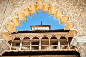 Scalloped archway frames balcony of Royal Alcazars in Spain