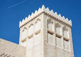 Building in the arabic architecture design and flying airplane photo