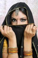 Beautiful brunette asian girl with black veil on face photo