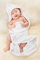 Chinese baby boy covered with white blanket photo
