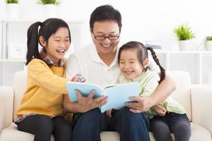 happy father read the book to children photo