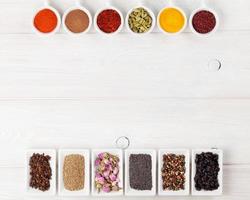 Various spices on white wooden background photo