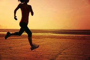 young fitness woman running on  beach