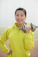 fitness woman working out with dumbbell photo