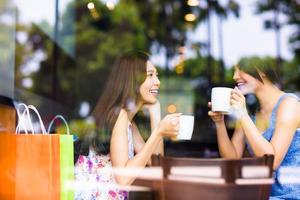 two young woman chatting in a coffee shop