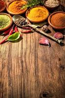 Herbs and spices on wooden table photo