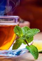 Tea in a glass cup, mint leaves photo