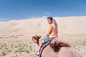 Young girl riding on the camel
