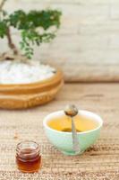 Green tea in a ceramic bowl with honey. photo