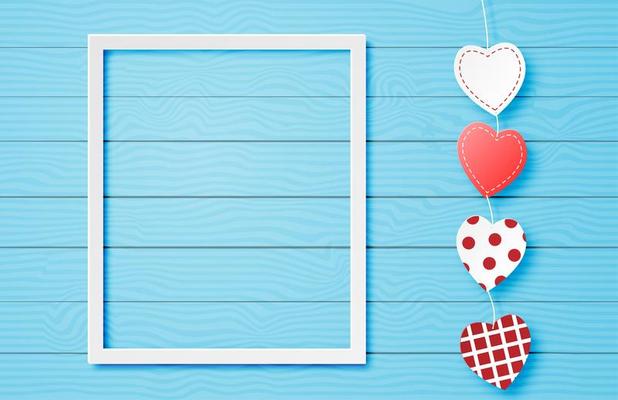 White frame with heart string on blue wood