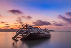 Abandoned fishing boat at sunset, Thailand. photo