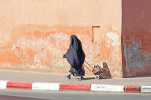 Muslim woman walking down the street photo