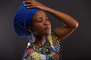 mujer africana en ropas tradicionales con los ojos cerrados
