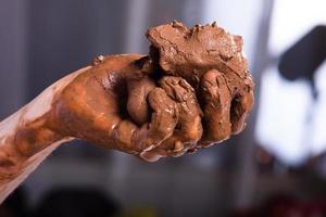hands of a potter with clay, closeup photo