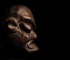 African mask over black background photo