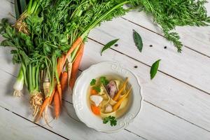 Homemade broth with noodles and ingredients photo