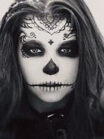 Beautiful woman with halloween sugar skull make-up