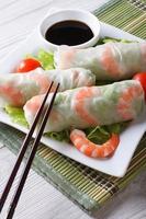 spring roll with shrimp and sauce on a plate. Vertical photo