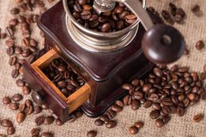 Antique coffee grinder and coffee beans