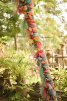 Thai Buddhist Ribbon Wrapped Pole, Thailand photo