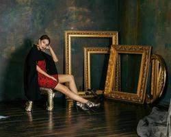 beauty rich brunette woman in luxury interior near empty frames