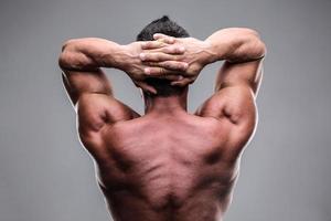 Rear view of a muscular man photo