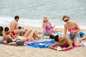 People sunbathing on the beach photo